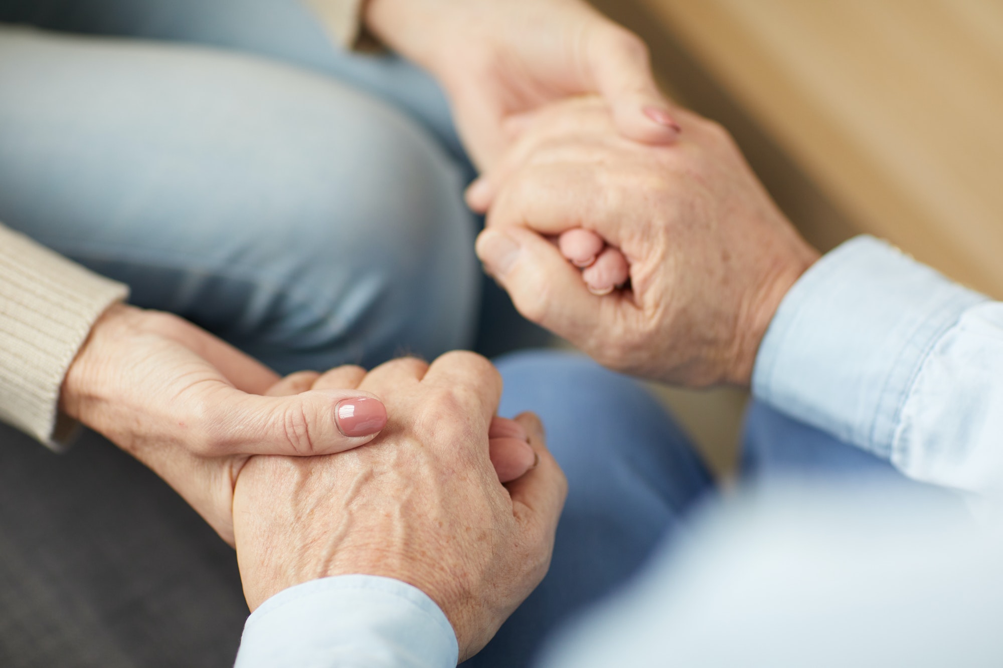 caring-senior-couple-holding-hands
